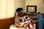 Women Setting Up Food Table, November 1979