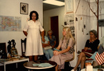 Woman Speaks To a Group of Four Women