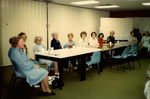 Women Sitting Around One Long Table