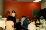 Two Women Having a Conversation In a Room Full of People