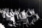 Women Sitting In Rows At a Workshop