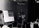 Women Standing Around Whiteboard