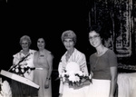 Women Holding Flower Arrangements