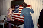 Women Setting Up An American Flag