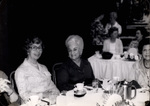 Women Sitting Around a Set Table