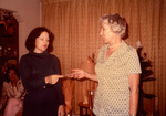 Woman Handing Check To Another Woman