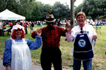 A Woman In Costume, a Man And An Altrusa Volunteer Pose For Photo.