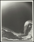 A close aerial view of an unknown island and bordering waterway