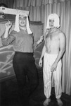 Two men in wigs at Jimmie White's Tavern by Bobby, 1923-2008 Smith