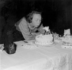 Mary blowing out candles on a birthday cake