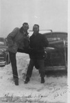 Two men leaning against a car in the snow by Bobby, 1923-2008 Smith