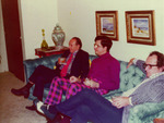 Three men on a blue couch