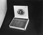 Advertisement photograph featuring a box of Bering Corona Grande cigars