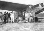Mayor Perry G. Wall (Far Right) and Postmistress Elizabeth Barnard (Third from Right) Pose with a Group and Mail Sacks Near An Airplane, April 1, 1926