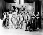 Moulin Rouge Dance Troupe in Choreographed Pose, with Musician Backup and Broadcast Paraphernalia in Tampa, Florida