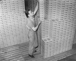 Man Stacking Boxes of Tampa Nugget Cigars at the Hav-a-Tampa Cigar Company, January 23, 1939 by Burgert Brothers