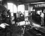 Men working at newspaper printing presses by Burgert Brothers