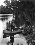 Man and boy fishing from a canoe on the Hillsborough River by Burgert Brothers