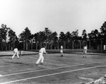 Three Men and One Woman Play a Tennis Doubles Match by Burgert Brothers