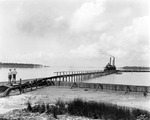 Two men near dredge and pipeline on Old Tampa Bay near Oldsmar by Burgert Brothers