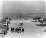 Shelters and swimmers at Sunset Beach on Treasure Island by Burgert Brothers
