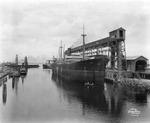 Ship "Hanover" docked next to the Atlantic Coast Line elevator at Port Tampa by Burgert Brothers