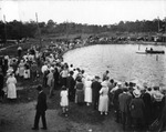 Spectators watch competitive swimmers at the Sulphur Springs Pool by Burgert Brothers