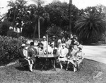 Women's Group Poses Around a Table for a Group Portrait by Burgert Brothers