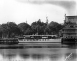 Yacht docked at Tampa Bay Hotel near boathouse by Burgert Brothers