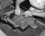 Woman Cigar Maker Rolling a Broad Leaf Wrapper Around a Cigar at Cuesta Rey and Company