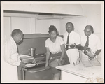 Group of people cooking in a kitchen