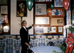Cesar Gonzmart admires the framed publicity articles in the Columbia Restaurant's Cafe