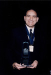 Casey Gonzmart holds the Tampa Bay Business Hall of Fame Award