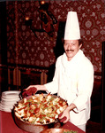 Unidentified chef serving paella at the Columbia Restaurant
