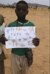 Boy holdings his drawing of the war in Darfur