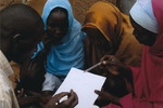 Women and girls studying in a refugee camp