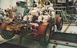 Apollo 15 Commander David Scott, right and Lunar Module Pilot James Irwin participate in a suited simulated mission run on the Lunar Rover Vehicle