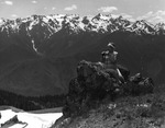 Helen Cruickshank sits atop a boulder in Olympic National Park by Allan D. Cruickshank