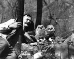 A man poses with two owls by Allan D. Cruickshank
