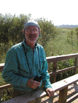 Peter Merritt poses with a pair of binoculars, Leesburg, Florida