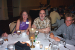 Peter and Victoria Merritt smile beside Andy Bankert during a Florida Ornithological Society (FOS) meeting in Mount Dora