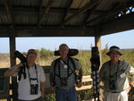 Three Florida Ornithological Society (FOS) members pose with their cameras and tripods during a birding trip in Leesburg