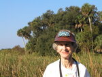 Mary Davidson smiles against a backdrop of tall grass and palm trees in Leesburg by Florida Ornithological Society