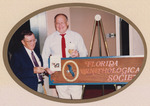 Bill Robertson and Glen Woolfenden pose with a Florida Ornithological Society (FOS) sign by Florida Ornithological Society