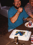 Wes Biggs laughs beside a 700th bird cake at Archbold Biological Station by Florida Ornithological Society