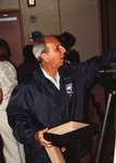 Orlando Garrido gestures with an open board game during the Florida Ornithological Society (FOS) 1994 spring meeting in West Palm Beach by Florida Ornithological Society