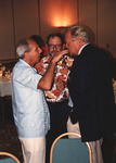 Orlando Garrido, Herb Kale, and Woody Bracey chat closely during the Florida Ornithological Society (FOS) 1994 spring meeting in West Palm Beach