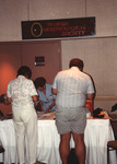 Wayne Hoffman and other Florida Ornithological Society (FOS) members stand at an information table during the 1994 meeting in West Palm Beach by Florida Ornithological Society