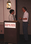 Fred Lohrer and Greg Butcher speak behind the podium at the Florida Ornithological Society (FOS) 1994 meeting in West Palm Beach