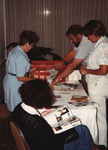 Wayne Hoffman, Chris Collins, and other Florida Ornithological Society (FOS) members stand at an information table at the 1994 meeting in West Palm Beach